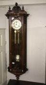 A mahogany double weight wall clock.