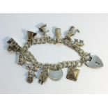 A silver charm bracelet with charms including silver