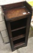 An early 19th century oak bookcase (glass missing).