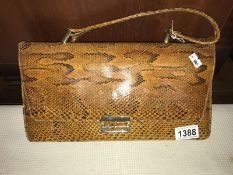 A snakeskin bag and purse.