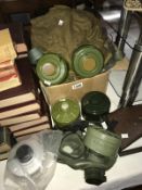 A modern gas mask with 5 filter canisters and military equipment bags and accessories.