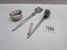 A silver tooth pick, a silver napkin ring, a silver paper knife and a cast owl paper knife.