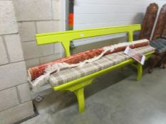 A painted bench with cushion.