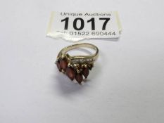 A Marquise garnet cluster ring in 9ct yellow gold, size N. Total weight 4.4 grams.