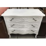 A white painted ornamental 3 drawer chest with seperatine front