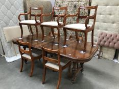 A good quality extending mahogany dining table with 2 leaves & 7 chairs