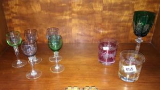 A small collection of etched & coloured glass drinking glasses