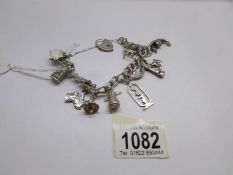 A good silver charm bracelet with 12 silver charms and padlock, 52 grams.