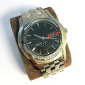 A rare Gent's Gucci wristwatch set diamonds, in working order.