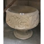 A fleur de lis urn depicting stylised 3 petal design