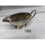 A silver sauce boat (97 grams).