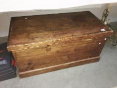 A wooden chest containing clothes