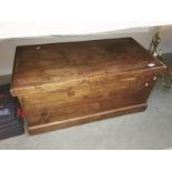 A wooden chest containing clothes
