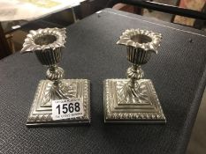 A pair of ornate silver plate candlesticks.