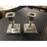 A pair of ornate silver plate candlesticks.