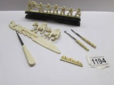 A mixed lot of ivory and bone items including 'monkey line' on stand, 2 oxen with riders,