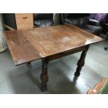 A 1930's oak drawleaf table
