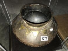 An Asian metal cooking pot.