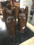 A pair of carved wood angels.