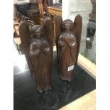 A pair of carved wood angels.