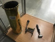 A brass trench art shell case, a cartridge maker and a gun powder measure.