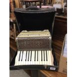 A cased Hohner piano accordion.