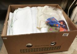 A box of linen including table cloths etc.