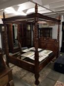 A 5ft mahogany four poster bed.