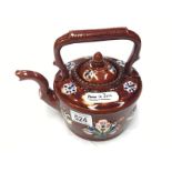 A home is best' brown glazed teapot with floral decorations