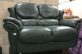 A green leather 2 seater sofa