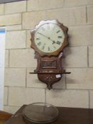 A mahogany wall clock, door a/f.