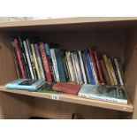 A shelf of assorted books including gardening books