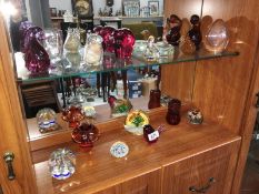 A large selection of glass paperweights & ornaments (2 shelves)