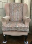A floral pink covered armchair