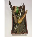 A small box of miscellaneous metal household items including corkscrews,