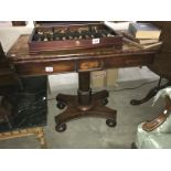 A mahogany fold over games table.