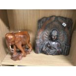 An oriental resin wall plaque with bronzed finish and wooden elephant (1 tusk missing A/F)