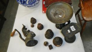 A set of scales with weights & a hand cranked meat mincer