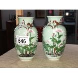 A pair of green decorated ceramic vases - bird & relief - cast flowers