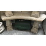 A curved stone seat on squirrel plinths