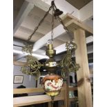 A brass and ceramic ceiling light,.