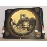A large illuminated chalkware plaque with integral clock & wall lights