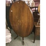 An oval inlaid mahogany tip top loo table.