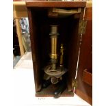 A Victorian wood cased brass microscope.