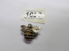 A silver tigers eye pendant fashioned as a bee. Total weight 5.46 grams.