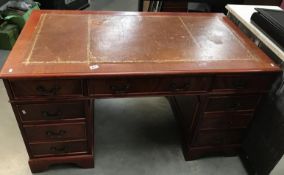 A dark wood stained double pedestal desk