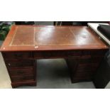 A dark wood stained double pedestal desk