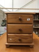 A solid pine 3 drawer chest of drawers