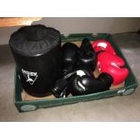3 pairs of boxing gloves and a round kick boxing protection pad