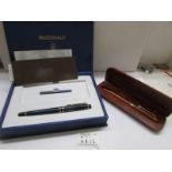 A boxed Waterman fountain pen and a Mouawad ball point pen in wooden case.